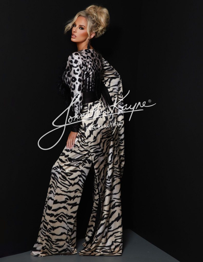 Johnathan Kayne’s Style 2884 is not just a jumpsuit—it’s a moment. Drenched in power and personality, this look channels the bold spirit of the woman who refuses to blend in. With an exotic animal print that prowls across a metallic pleated knit fabric, this piece is as untamed as it is elegant.